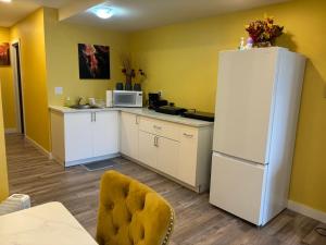 a kitchen with a white refrigerator and a microwave at Home away from home in Winnipeg