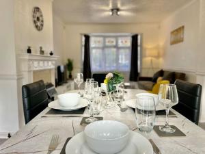 - une table avec des assiettes et des verres à vin dans l'établissement Great location, near M25 & A12 - Free Parking, à Great Warley Street