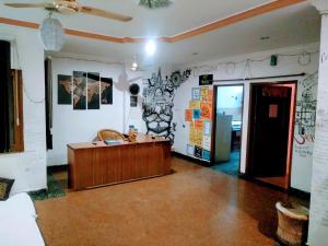 a room with a desk in the middle of a room at Nomadic Hostel in Udaipur