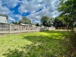 a backyard with a fence and a grass field at Great location, near M25 & A12 - Free Parking in Great Warley Street