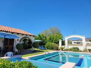 a swimming pool in front of a house at Casa Magdalena in San Carlos