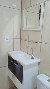 a bathroom with a sink and a toilet at Chalé Encantadas Eco Ilha Preserve in Ilha do Mel