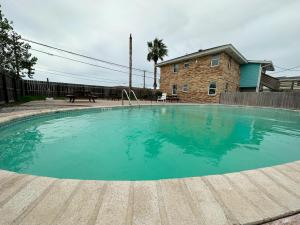 a large swimming pool in front of a house at Village Inn Motel in Rockport