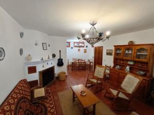 a living room with a couch and a fireplace at Casa Rural La Argentina in Bubión