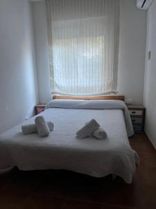 a bedroom with a bed with two pillows on it at Balcón de La Iruela I in La Iruela +28 photos
