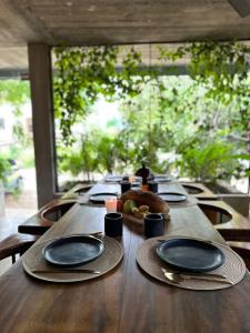 a long wooden table with plates and napkins on it at AORA San Pancho in San Francisco +24 photos