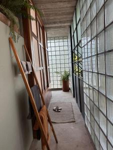 a hallway with chairs in a room with windows at AORA San Pancho in San Francisco