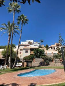 een zwembad voor een huis met palmbomen bij House in Andalucia, SPAIN in Salobreña