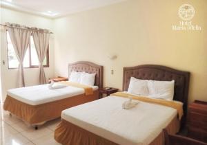 Un pat sau paturi într-o cameră la Hotel y Restaurante Maria Ofelia
