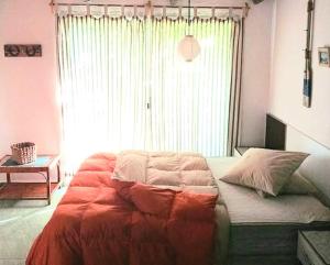a bed in a bedroom with a large window at El secreto in Ciudad de la Costa