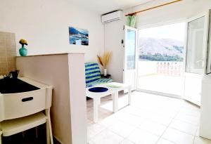 a kitchen with a sink and a table and a window at Stanko Sea View in Metajna +46 photos