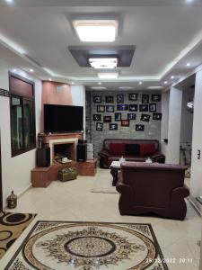a living room with a couch and a television at Marrakech golf city in Marrakech