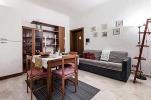 a living room with a table and a couch at MilanRentals - Baires Apartment in Milan