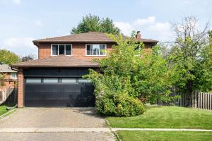 a brick house with a garage at Stylish & Spacious Guesthome With More Than Essentials in Newmarket