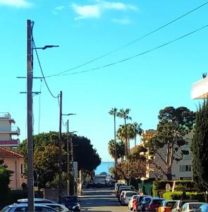 a street with cars parked on the side of the road at Cabane pas loin de la plage in Cagnes-sur-Mer