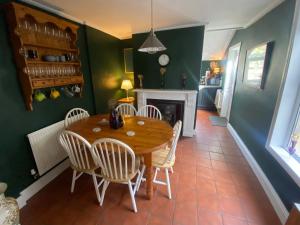 a dining room with a wooden table and chairs at Cardiff - Home from Home in Cardiff