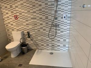 a bathroom with a shower with a toilet and a sink at La Veranda Hotel in Larnaka