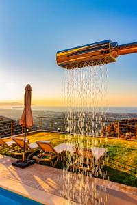 a water fountain in the middle of a pool at Villa Lia Chania with private ecologic pool and amazing view! in Chania Town