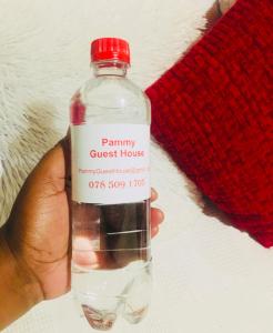 a person is holding a bottle of water at Pammy Guest House in Richards Bay