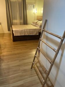 a ladder standing in a room with a bed at Aesthetic Functional Minimalist Space Sunvida Tower SV1716 in Cebu City