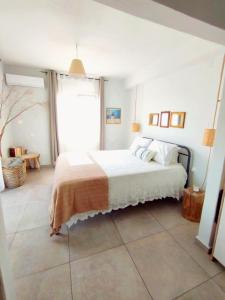 a bedroom with a bed and a large window at Ammoudara's apartments Rooftop in Kalymnos