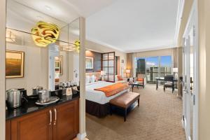 a hotel room with a king sized bed and a desk at Lucky Gem Luxury Suite MGM Signature, Balcony Strip View 1607 in Las Vegas