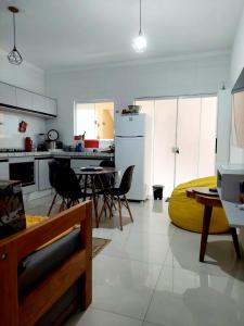 uma cozinha e sala de jantar com mesa e cadeiras em Apartamento Ubatuba Maranduba 150m da Praia em Ubatuba