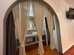 an arched doorway with curtains in a room at บ้านมัจฉา in Ko Larn