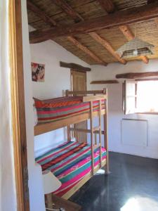 a couple of bunk beds in a room at La Calabaza Cabaña in Tilcara
