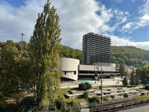 a large building in front of a tall building at Zahradni in Karlovy Vary