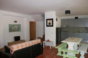 a living room with a couch and a table at Casas do Corvo in Ventosa