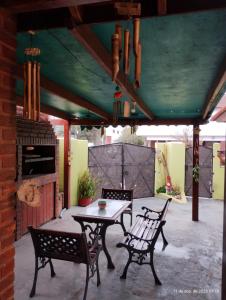 a patio with a table and chairs on a patio at Modernos departamentos PB cerca del centro y del mar in Mar de Ajó