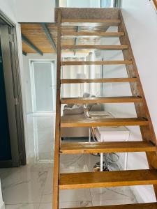 a wooden staircase leading up to the top of a room at The Tiny Village Couple Retreat in Cabo Rojo