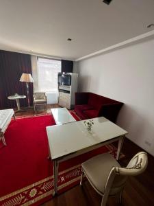 uma sala de estar com uma mesa branca e um tapete vermelho em Habitación exclusiva em Buenos Aires