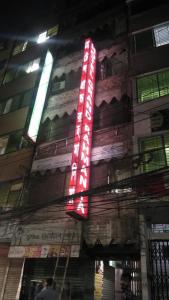 um sinal de néon na lateral de um edifício em Hotel Grand Rahmania, Central Motijheel-Dhaka em Daca