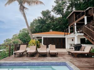 a villa with a swimming pool and a house at Moringa Villa Master Suite in Soufrière