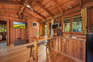 a kitchen with a wooden counter and a sink at MANGO LODGE River Heads in River Heads