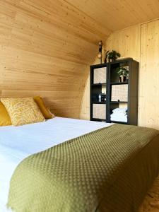 a bedroom with a bed and a wooden wall at Bungalow Madeira - Casa das Lages - Almancil - Quinta do Lago in Almancil