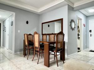 a dining room with a table and chairs at Apartamento 3 quartos e boas energias in Balneário Camboriú