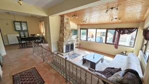 a living room with a couch and a fireplace at Lithos Villas Kalavryta in Kalavrita