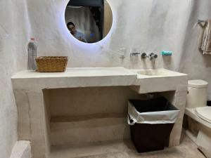a bathroom with a sink and a mirror at Cabañas Casvar in Balcheil