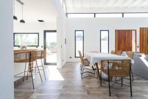 a dining room with a white table and chairs at Perseo 1422 in Pinamar