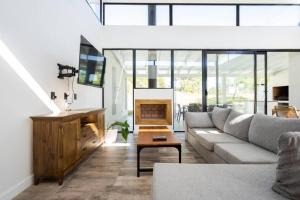 a living room with a couch and a fireplace at Perseo 1422 in Pinamar