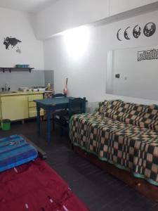 a room with a bed and a table in it at Ayre del Tuyu in Mar del Tuyú