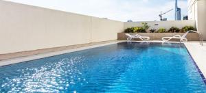 a swimming pool on the side of a building at The Belvedere Marina Inn, Heart of Marina in Dubai