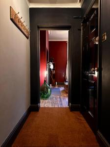 a hallway with a room with red walls at The Bolt Hole in Stratford-upon-Avon