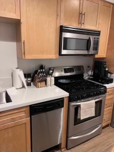 a kitchen with a stove and a microwave at Cozy Santa Monica getaway steps to the beach Free Parking in Los Angeles