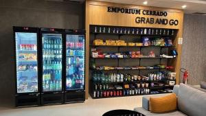 a soda shop with two refrigerators and drinks on the shelves at Blend SmartStyle by Marzani Host in Goiânia