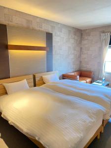 a bedroom with two large beds and a window at Bar 39 in Higashihiroshima