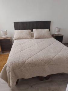 a bedroom with a large bed with two night stands at Departamento nuevo en reñaca alto 2 dormitorios in Viña del Mar